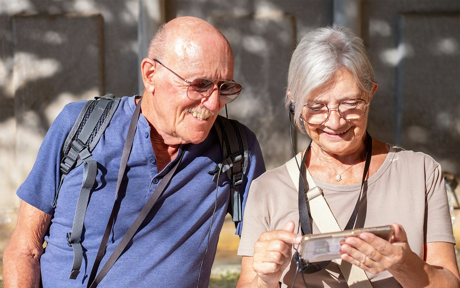 Tourists using audio guide in Paris's Latin Quarter with OPA SI Pass.
