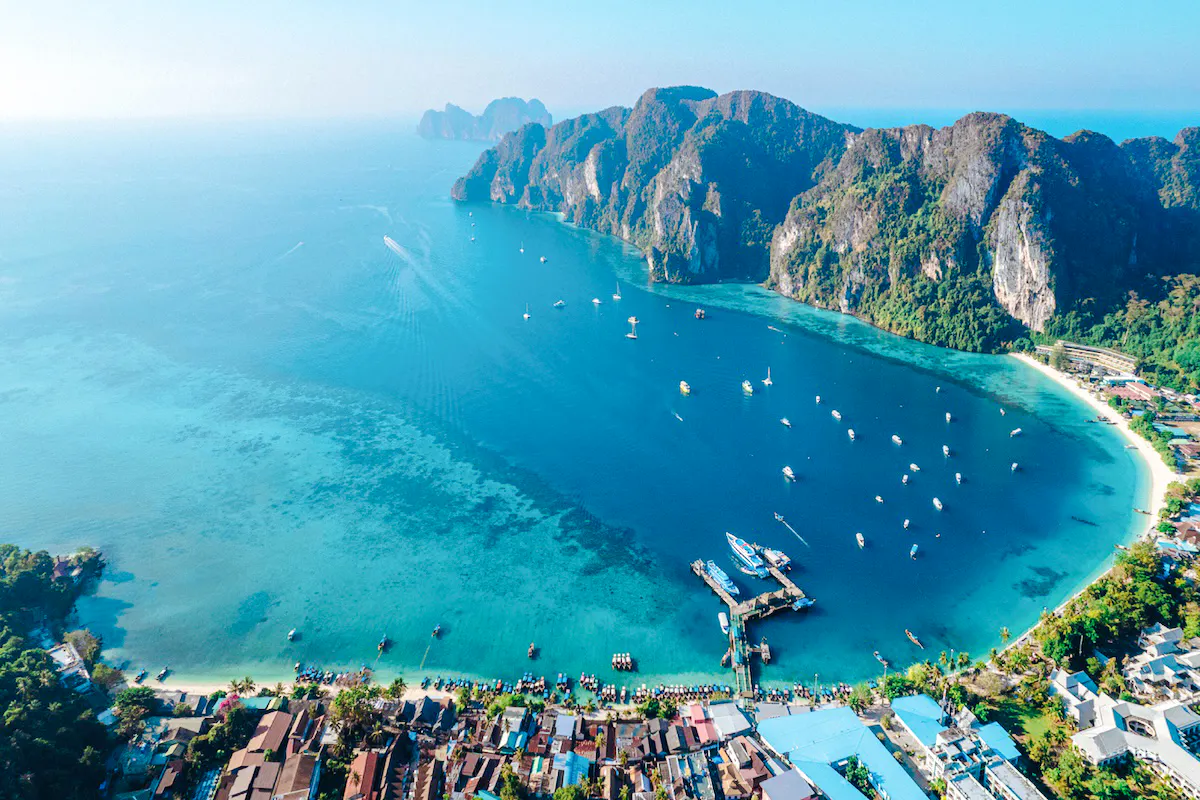Aerial view of ferry dock and boats in turquoise waters of Phi Phi Islands, Phuket.