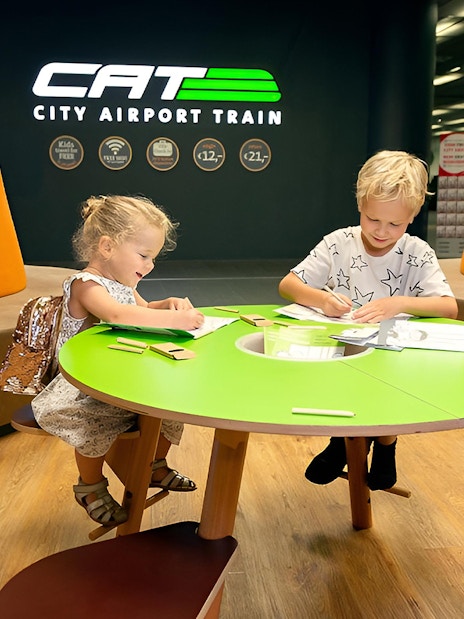 Children drawing at Vienna City Airport Train lounge.