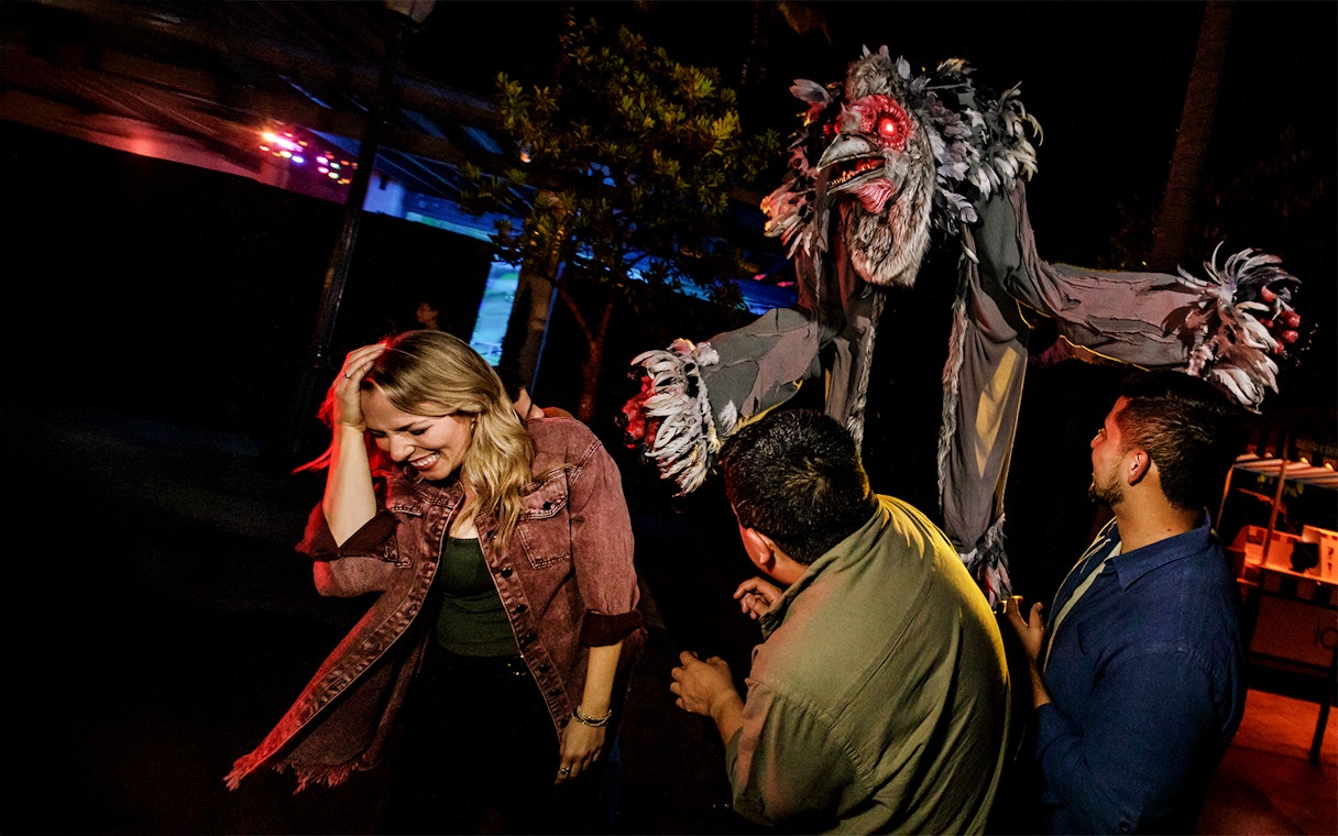 Guests reacting to a creature at Hollywood Horror Nights, Universal Studios Hollywood, Los Angeles.