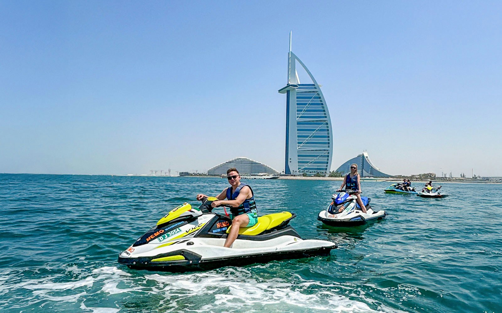 Tourists jet skiing near Burj Al Arab in Dubai.