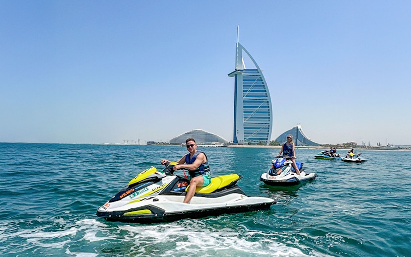 Tourists jet skiing near Burj Al Arab in Dubai.