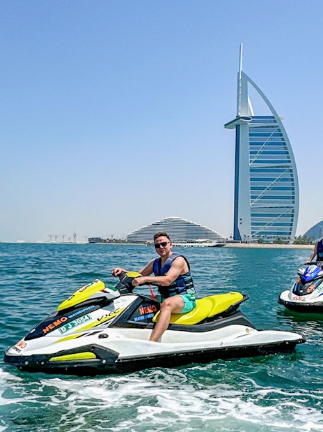 Tourists jet skiing near Burj Al Arab in Dubai.