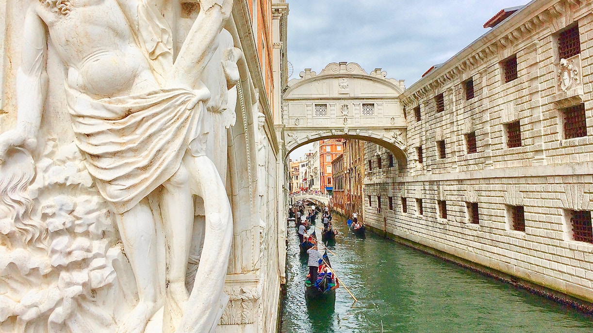 Gondola boat ride on canal near Bridge of Sighs, Venice.