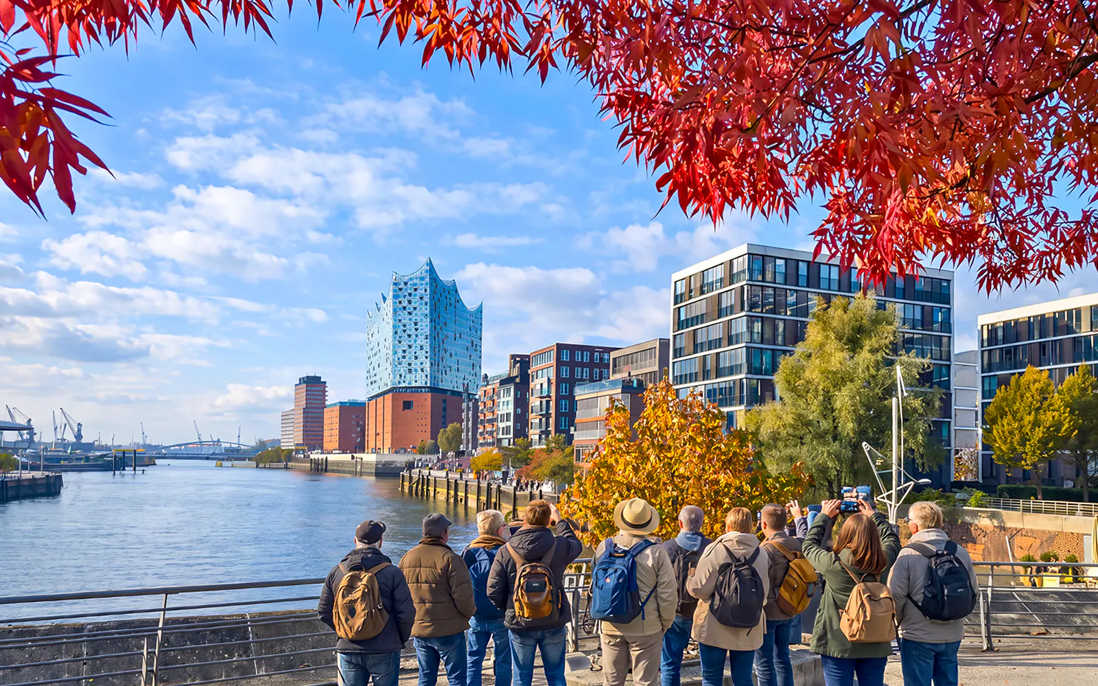 Group of tourists viewing Elbphilharmonie and HafenCity in Hamburg, Germany.