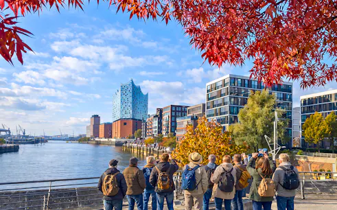 Group of tourists viewing Elbphilharmonie and HafenCity in Hamburg, Germany.