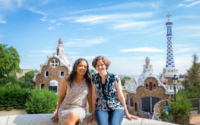 Visitors enjoying Park Güell's unique architecture on a guided tour in Barcelona.