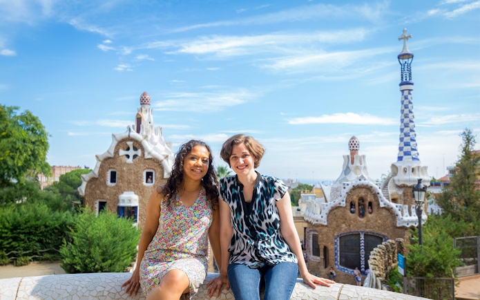 Visitors enjoying Park Güell's unique architecture on a guided tour in Barcelona.