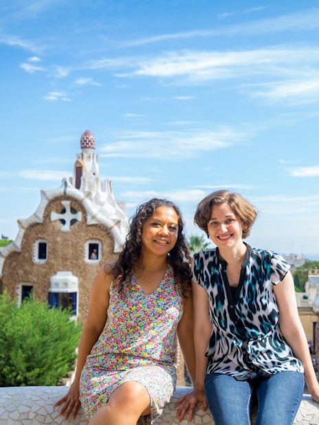Visitors enjoying Park Güell's unique architecture on a guided tour in Barcelona.