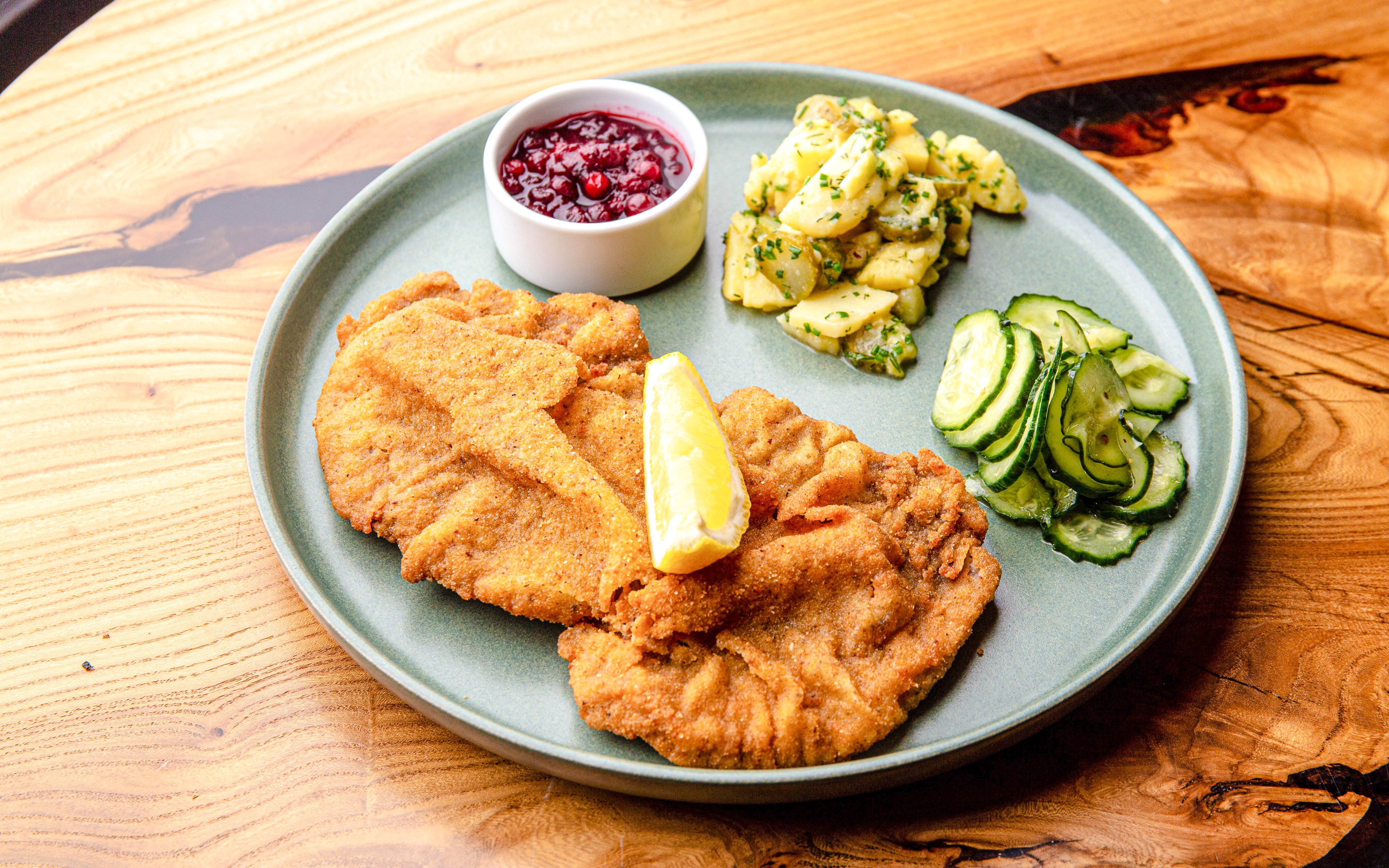 Schnitzel with lemon, potato salad, and cucumbers at Alpenrose am See.