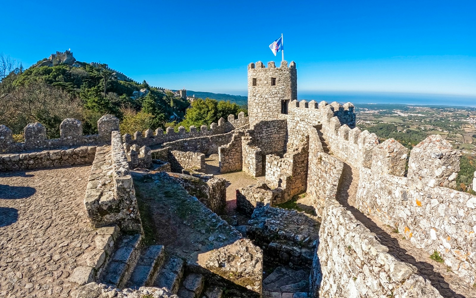 Moorish Castle stone walls and tower overlooking Sintra landscape.