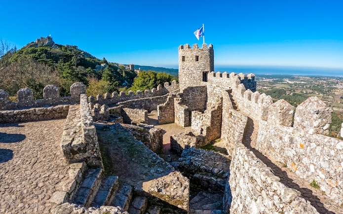 Moorish Castle stone walls and tower overlooking Sintra landscape.