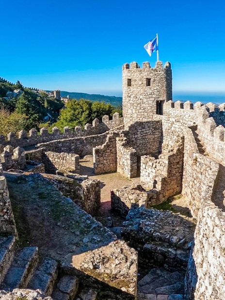 Moorish Castle stone walls and tower overlooking Sintra landscape.