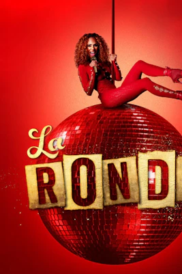 Performer in red outfit on a red disco ball with "La Ronde" text, Sydney.