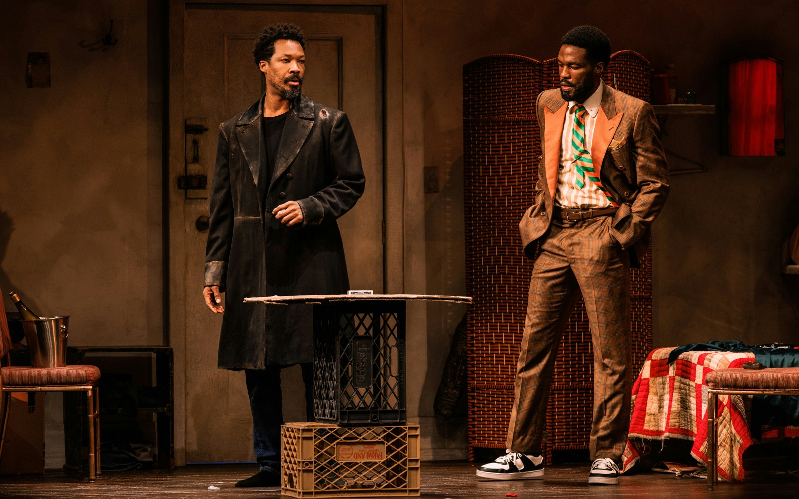 Two actors on stage in a scene from "Topdog/Underdog" play.