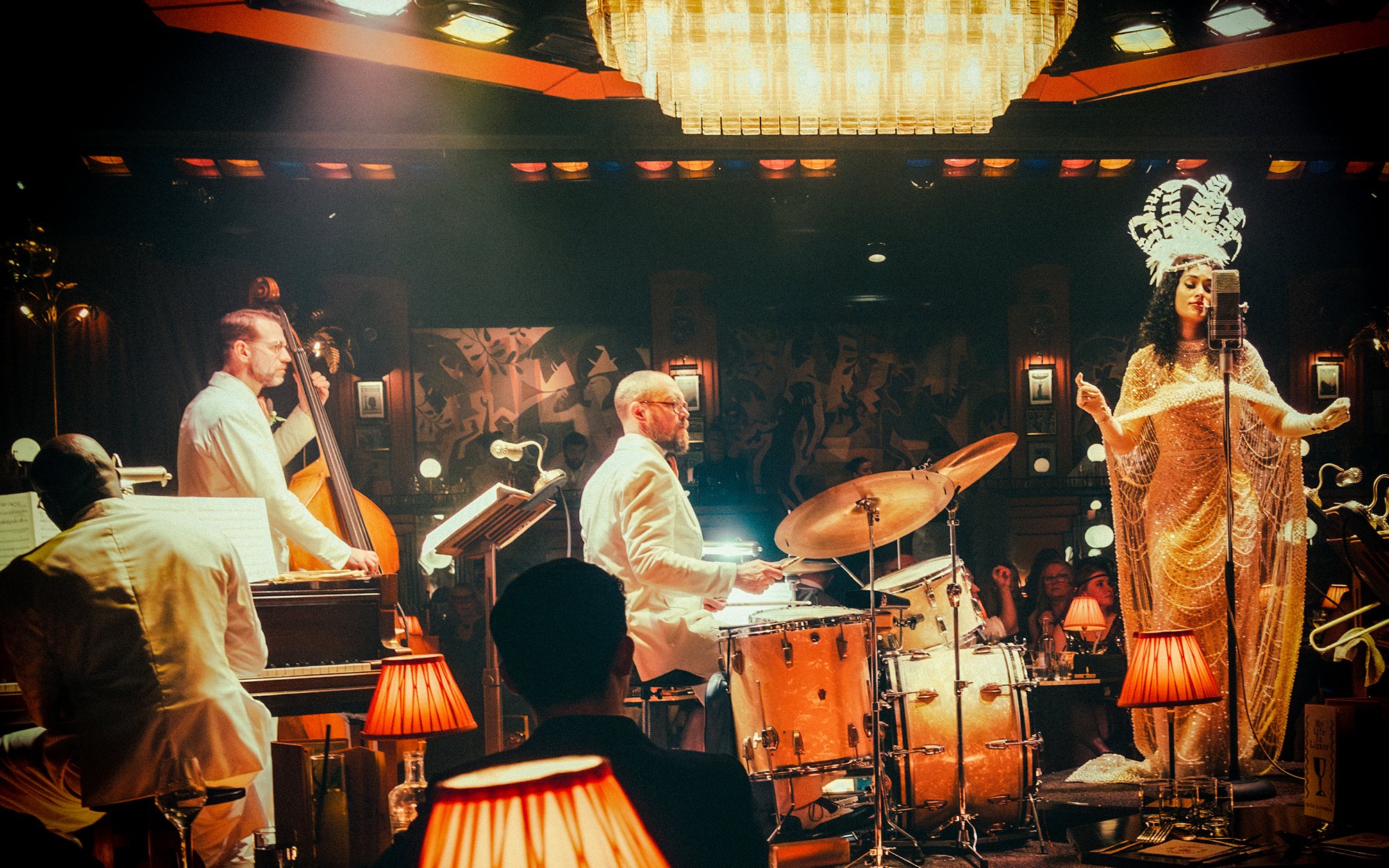 Jazz band performing on 58th Street with singer in vintage attire and musicians playing instruments.