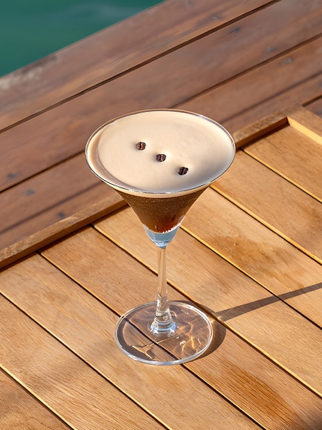 Cocktail on wooden table at Yona Beach Club, Phuket.