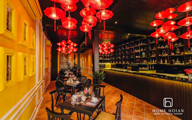 Dining area with red lanterns at HOME Hoi An Restaurant, offering all-you-can-eat Vietnamese cuisine.
