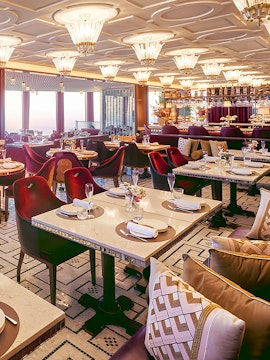 Dining area at Atmosphere Restaurant, Burj Khalifa, with elegant table settings and panoramic views.