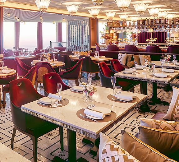 Dining area at Atmosphere Restaurant, Burj Khalifa, with elegant table settings and panoramic views.