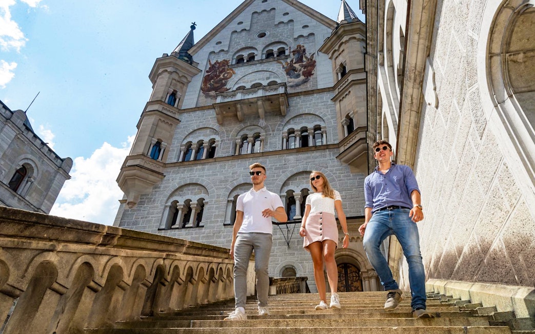 Visitors descending stairs at Neuschwanstein Castle, Germany.