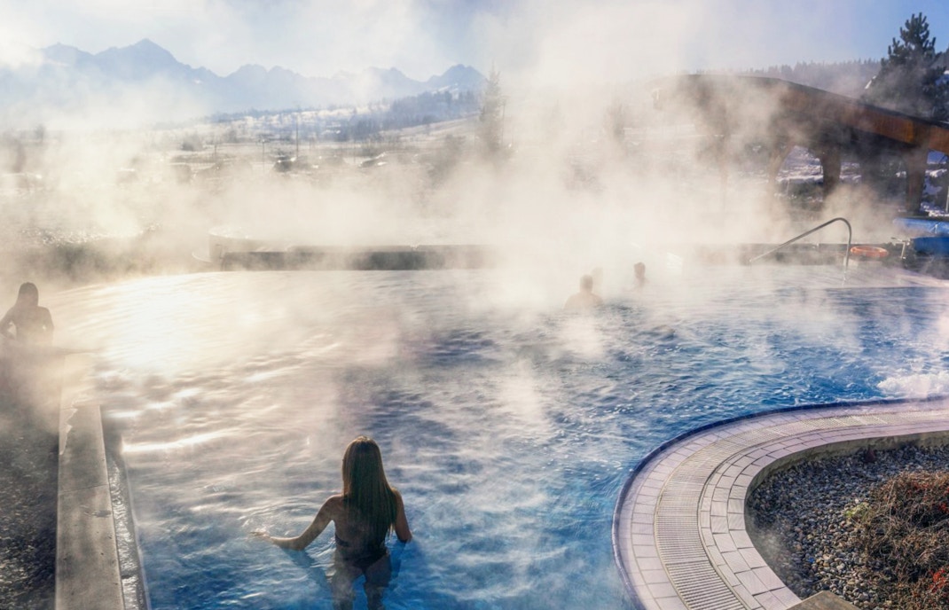 Visitors enjoying Chocholow Thermal Baths with scenic mountain backdrop in Zakopane, Poland.