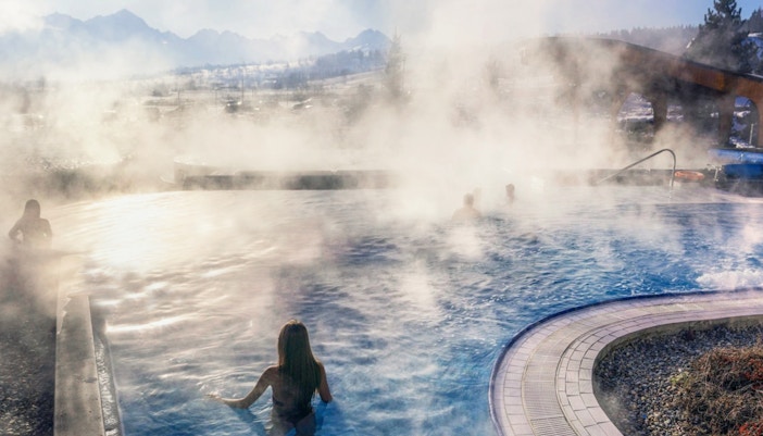 Visitors enjoying Chocholow Thermal Baths with scenic mountain backdrop in Zakopane, Poland.