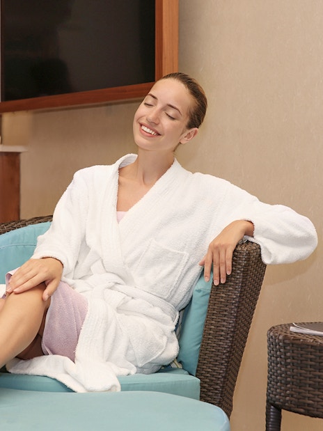Guest relaxing in a robe after Sifa Hamam session.