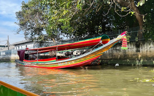 Long-tail boat on Bangkok Yai Canal during guided tour.