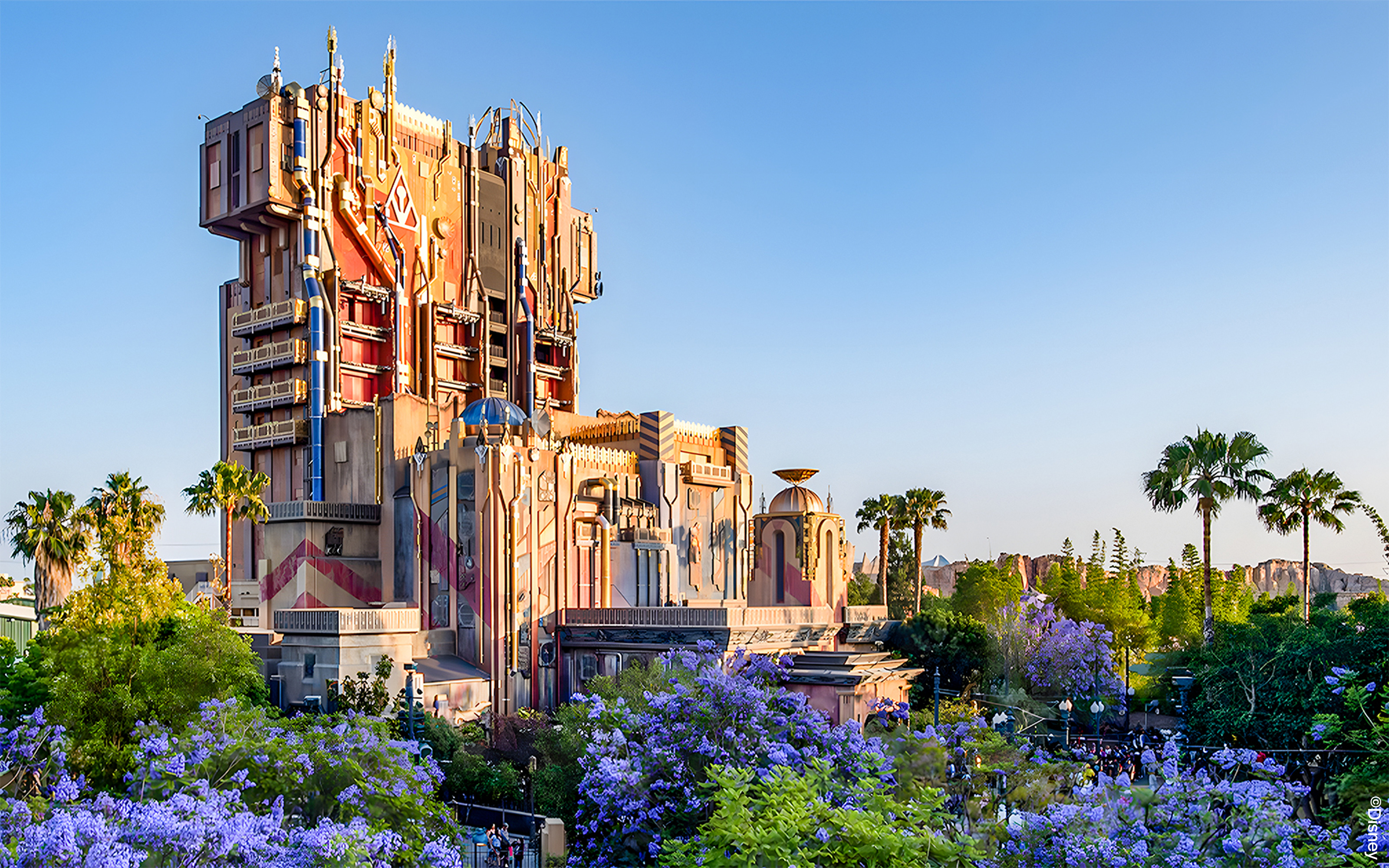Guardians of the Galaxy attraction at Disneyland Adventure Park, California, surrounded by palm trees and flowers.