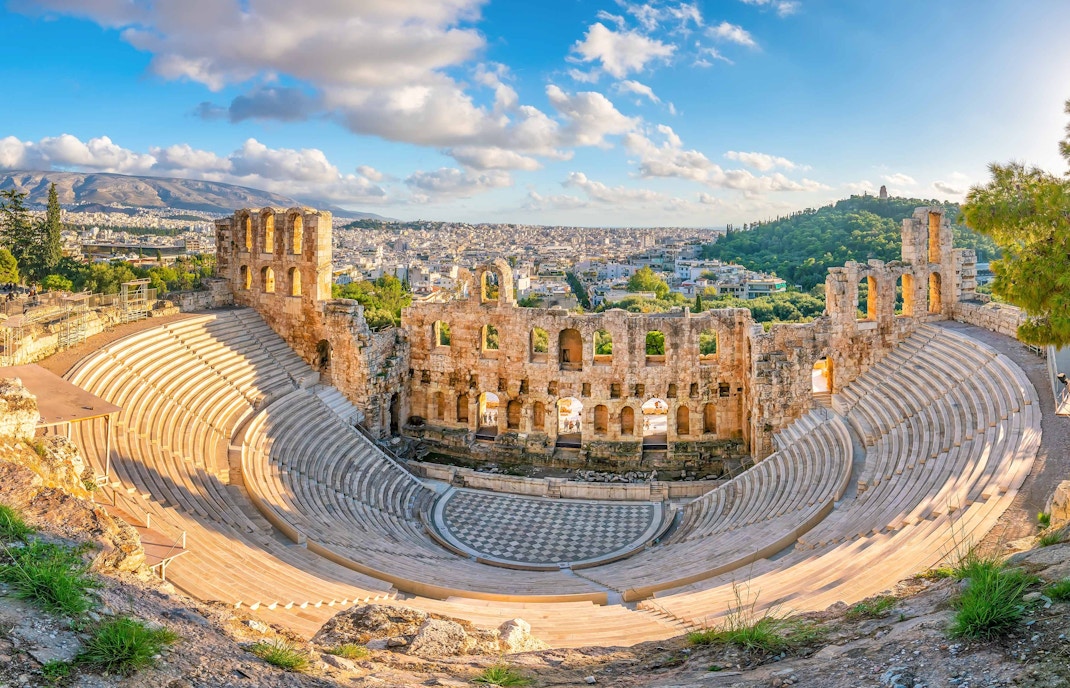 Odeon of Herodes Atticus amphitheater in Athens, Greece, with ancient stone seating and stage.