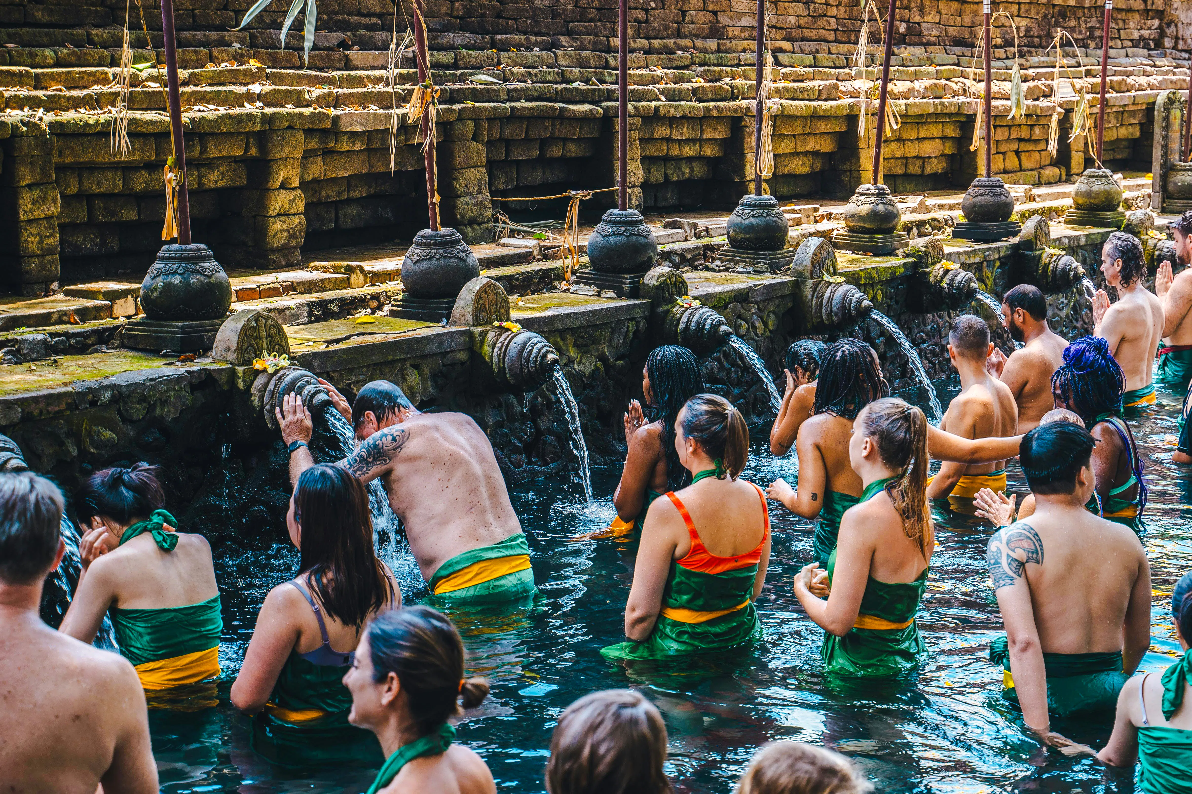Visitors participating in water purification ritual at Tirta Empul Temple, Bali.
