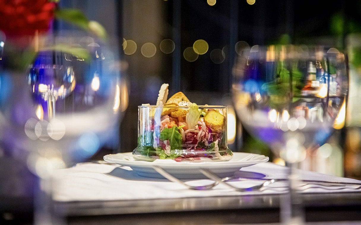 Chef preparing Czech tapas dish during cuisine tasting tour.