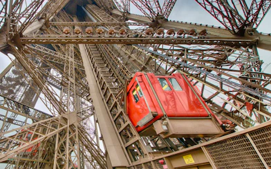 Eiffel Tower elevator ascending through iron structure in Paris.