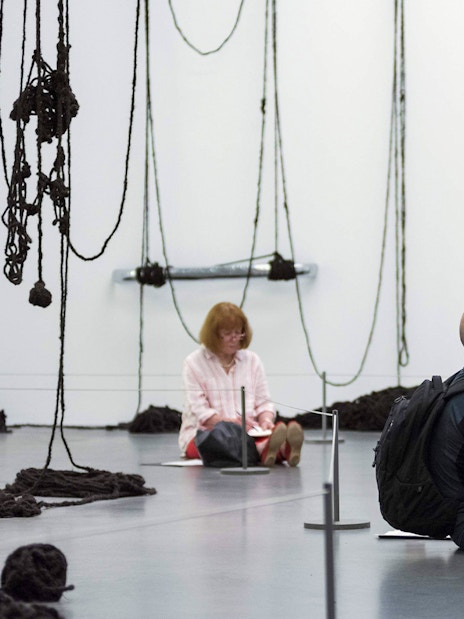 Visitors sketching art installations at Tate Modern, London.
