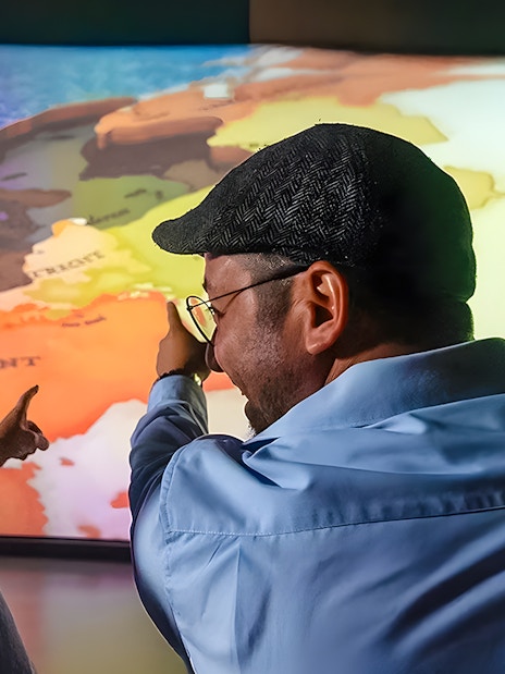 Tourists pointing at map during 5D ride at This Is Holland Ultimate Flight Experience.