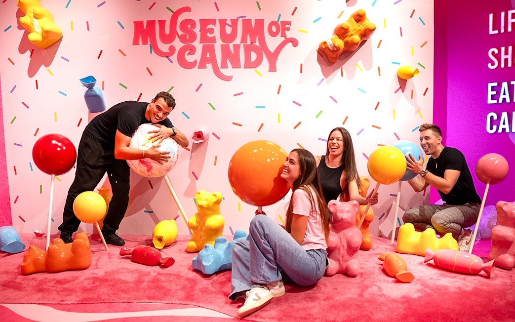 Guests interacting with giant candy sculptures at Museum of Candy, Dubai.