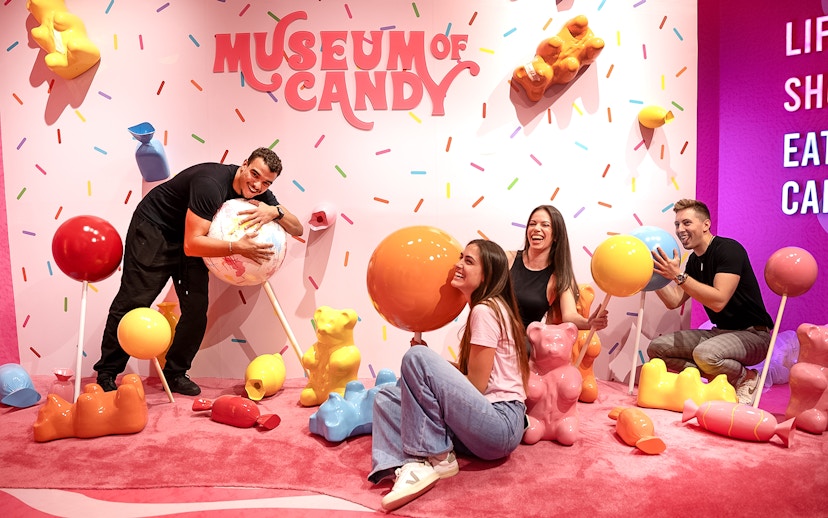 Guests interacting with giant candy sculptures at Museum of Candy, Dubai.