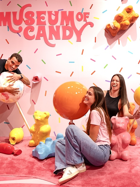 Guests interacting with giant candy sculptures at Museum of Candy, Dubai.