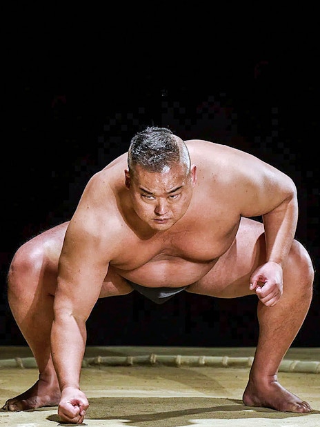 Sumo wrestler in stance at The Sumo Hall Hirakuza Osaka.