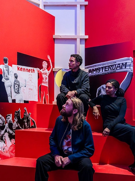 Visitors at the Amsterdam in Motion exhibit featuring Ajax football club history.
