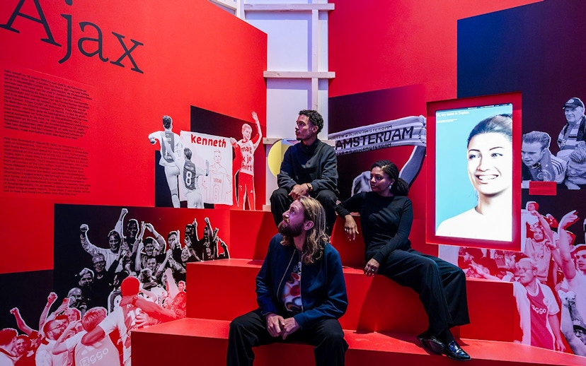 Visitors at the Amsterdam in Motion exhibit featuring Ajax football club history.