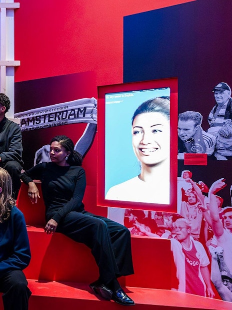 Visitors at the Amsterdam in Motion exhibit featuring Ajax football club history.