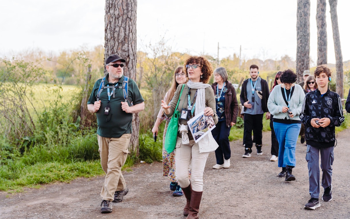 Tour group walking along the Appian Way during the Underground Rome Catacombs Tour.