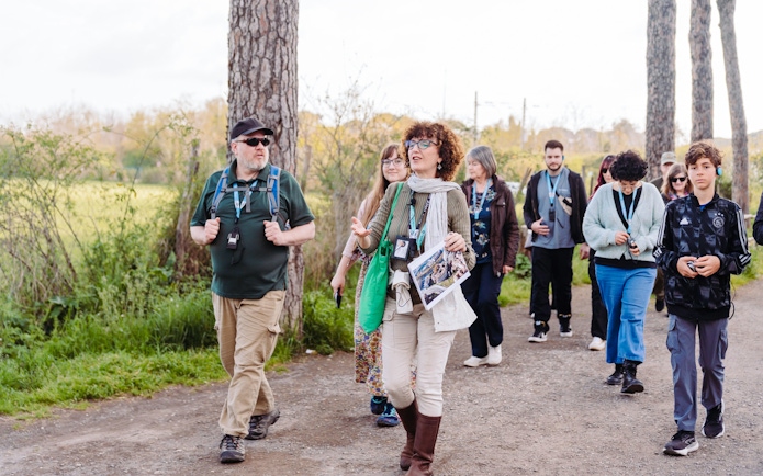Tour group walking along the Appian Way during the Underground Rome Catacombs Tour.