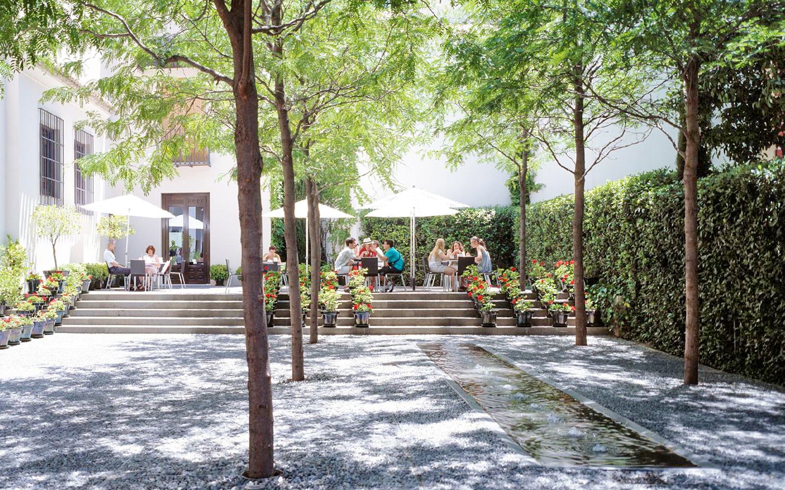 Visitors enjoying outdoor seating at Picasso Museum Malaga cafe.