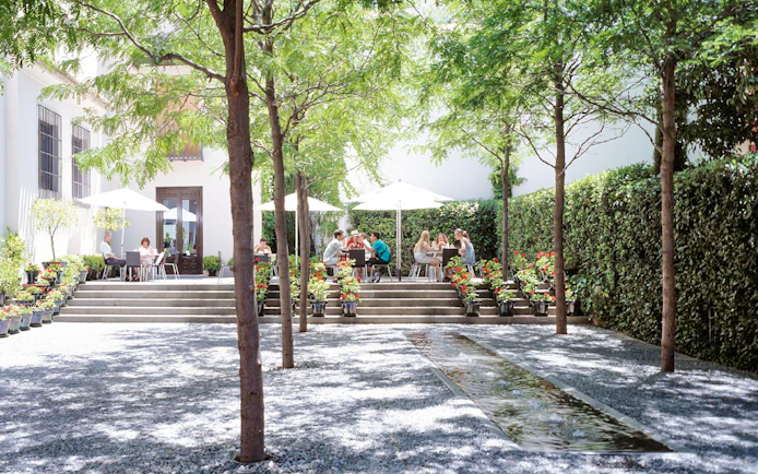 Visitors enjoying outdoor seating at Picasso Museum Malaga cafe.