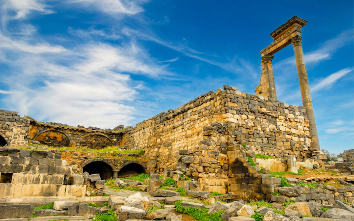 Roman ruins at Umm Qais, ancient Gadara, with stone arches and columns in northern Jordan.