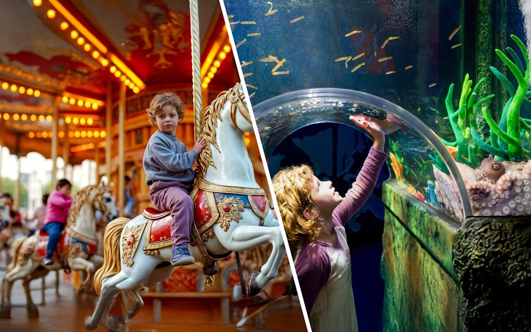 Child reaching towards fish in underwater tunnel at SEA LIFE Melbourne.