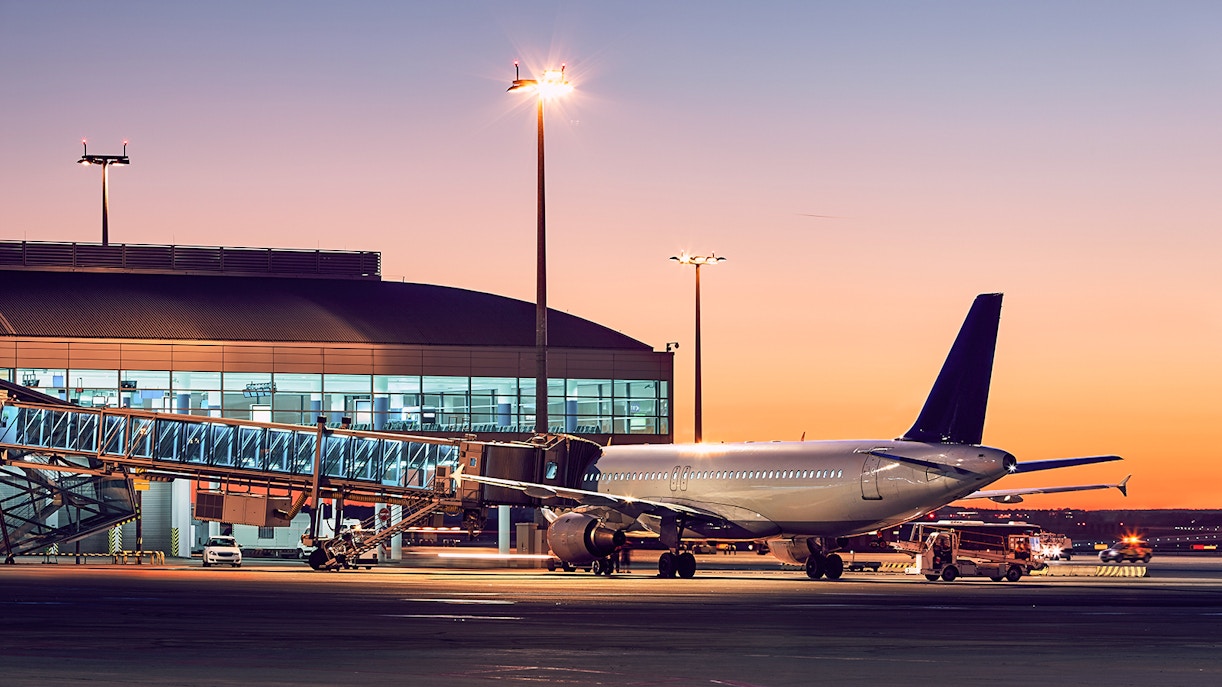 London City Airport transfer at sunset with planes on the tarmac.